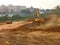 Excavation and ground leveling work using excavator machine and other heavy construction machinery