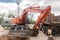 Excavation Works Industry. Industrial Heavy Machines Digging Equipment Dump Truck on Construction Site