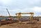 Excavator and auto crane working at construction of a new metro line.