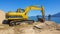Excavator on the beach moving sand