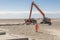 Excavator on the beach in Norre Vorupor, Denmark