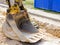 Excavator bucket at the construction site near the excavated trench