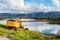 Excavator - bulldozer placed next to a big lake with mountain in Bronnoysund, Norway