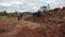 Excavator carries dirt to trench under builders control