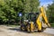 The excavator carries out repair work on the replacement of the roadbed. Translation of text on a plate into English: Rental of Ex