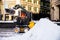Excavator city service cleaning snow winter tractor after snowstorm yard sunlight