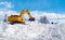 Excavator clearing snow