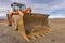 Excavator at the construction site of a road, moving earth