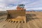 Excavator at the construction site of a road, moving earth