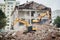 Excavator crasher machine at demolition on construction site