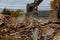 Excavator Demolition of an old house building for new construction project