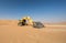 Excavator in the desert of Liwa