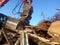 Excavator and destroyed building, earthquake, pile of rubble and debris, landfill