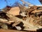 Excavator and destroyed building, earthquake, pile of rubble and debris, landfill