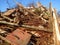 Excavator and destroyed building, earthquake, pile of rubble and debris, landfill