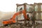 Excavator destroys old house.