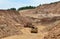 Excavator developing the sand on the opencast and loading it to the heavy dump truck.