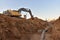 Excavator dig the trenches at a construction site. Trench for laying external sewer pipes. Sewage drainage system