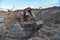 Excavator digg ground in open pit at landfill for work concrete demolition waste. Salvaging and recycling construction materials.