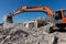 Excavator digging at construction site during house demolition