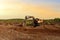 Excavator digging drainage ditch in peat extraction site. Drainage of peat bogs and destruction of trees. Drilling on bog for oil