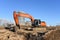 Excavator digs dirt during groundwork at construction site. Heavy machinery and earth-moving equipment for earthwork