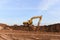 Excavator digs the ground for the foundation at construction site. Road repair, asphalt replacement, renovating