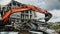 Excavator dismantles debris of old stadium under cloudy sky