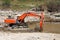 Excavator dredging sediment mud