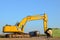 Excavator and dump truck at a construction site for installing concrete storm pipes. Backhoe the digging pipeline ditch.