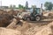 Excavator dumps the ground
