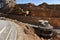 Excavator on earthwork during the laying of pipes of the heating system to a new residential building at the construction site.