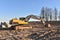 Excavator on earthworks at construction site. Backhoe on foundation work and road construction. Paving out sewer line. Heavy