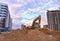 Excavator on earthworks at construction site. Backhoe on road work and laying sewer pipes. Construction machinery for dig ground,