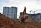 Excavator on earthworks at construction site. Backhoe on road work and laying sewer pipes. Construction machinery for dig ground,