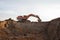 Excavator during excavation at construction site.  Backhoe on Earthworks. Heavy Construction Equipment Machines in Action.