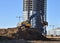 Excavator during excavation at construction site.  Backhoe on Earthworks. Heavy Construction Equipment Machines in Action. Big