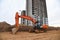 Excavator during excavation at construction site.  Backhoe on Earthworks. Heavy Construction Equipment Machines in Action. Big