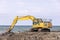 The excavator is excavation loading to truck. Construction equipment being used to dig up rocky ground.