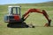 Excavator in field