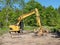 Excavator in the forest preparing construction of the hiking tr