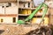 Excavator in front of a demolition site