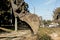 Excavator, grader and workers remove debris after dismantling a tram stop