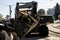 Excavator, grader and workers remove debris after dismantling a tram stop