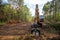 Excavator Grapple during clearing forest for new development. Tracked Backhoe with forest clamp for forestry work. Tracked timber