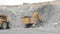 Excavator and heavy dump truck in open pit