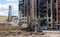 Excavator with hydraulic crusher at the demolition of a residential building. City renewal. Dismantling, destruction of a high-