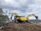 Excavator and hydrohammer during road construction on the rocky soils