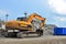 Excavator at Industrial landfill for the processing of old, old concrete structures.