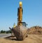 An excavator with its big shovel viewed from below